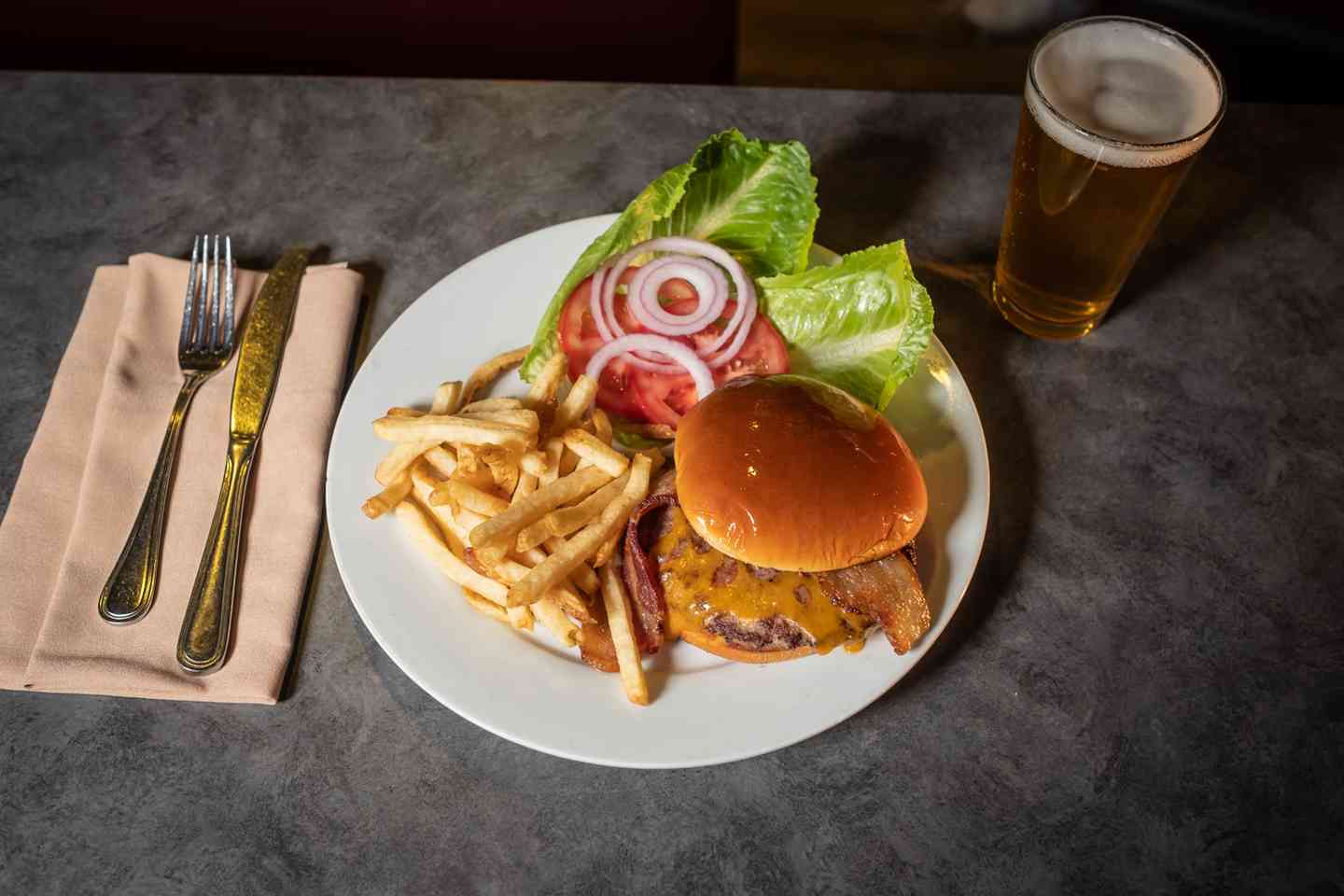 Burger with fries and salad fixings