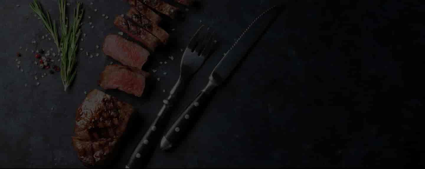 overhead shot of sliced cooked steak with five shots of prepared food in a grid underneath