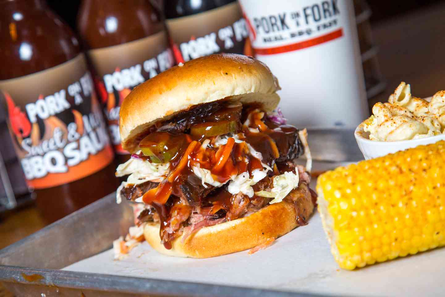 bbq pork sandwich with cole slaw and corn side