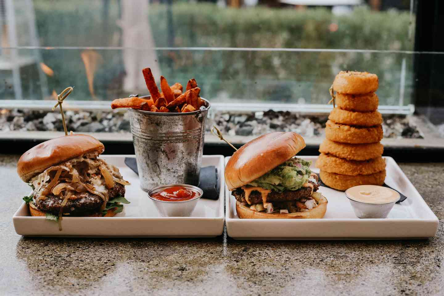 Multiple burgers with towering sides