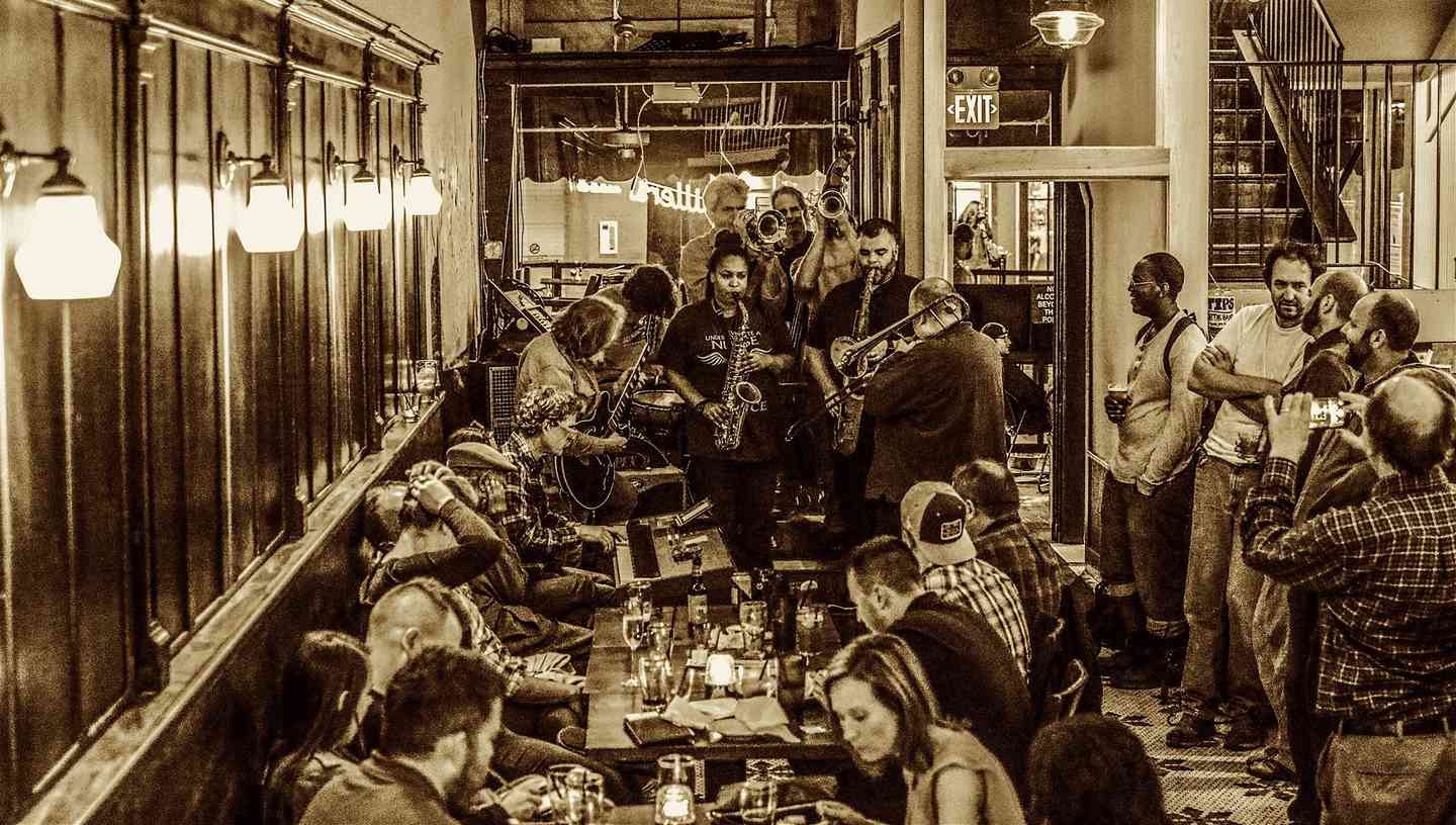 Sepia toned image of a crowded bar