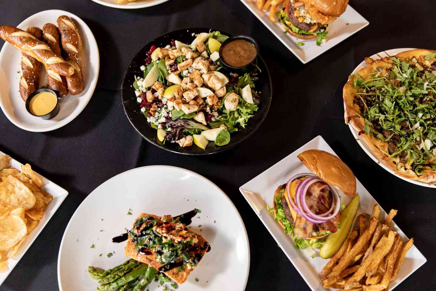 overhead shot of several plates of entrees and appetizers