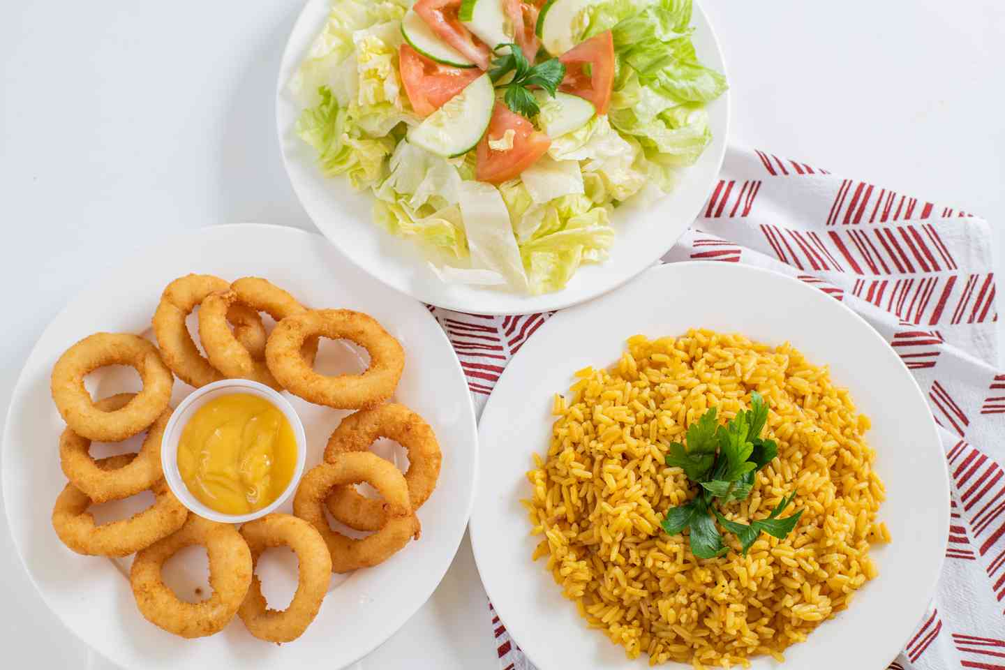Rice, onion rings and salad