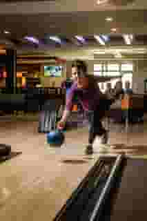 Woman throwing a bowling ball down a lane