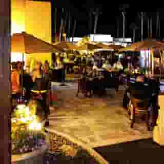 Outdoor dining tables with umbrellas front courtyard