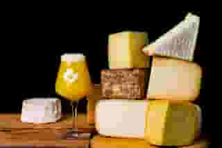 picture of 3 bottles of wine and large wedges of cheese