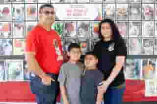 outdoor shot of owners and family in front of cart