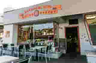 Front exterior and outdoor seating at Honey's Bistro & Bakery