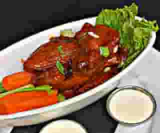 Chicken wings with dip, celery, and carrots
