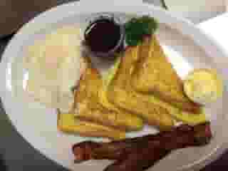 plate of eggs, french toast, and bacon