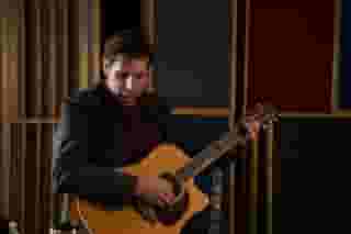 Chad Hoffman is a soulful singer/songwriter based just outside of Cleveland, OH. Chad is a passionate and engaging live performer whether he is playing his own material or reinterpreting cover songs. He is first and foremost an incredible singer, with a gritty, soulful voice and a broad vocal range. You don't only hear this in his voice, but you witness the intensity in his face throughout his performances. Beyond his powerful vocals, the next thing many people appreciate about Chad Hoffman's performances is the organic quality of his live sound. He embraces technology without relying on it. Compared to many of his peers who extensively use effects, pitch correction, vocal harmonizers, looping pedals and even backing tracks to synthetically thicken their mix, Chad takes a much more rootsy, DIY approach to his live sound. First, he typically uses minimalistic effects, applying just a bit of reverb to vocals and guitar. Second, he relies heavily on the unique rhythm guitar style he has developed over many years performing on his own, needing to create a thick, upbeat sound with only one guitar. But what really stands out in Chad's live shows is the homemade foot percussion instruments he incorporates into his live rig. These instruments allow him to create an upbeat, dynamic, full-band sound without selling his soul to the demigods of the looping pedal. He has designed and built several of these instruments out of reclaimed materials, with more in the works. Chad Hoffman is also an impressive songwriter and a budding producer. He pens deep and introspective lyrics and his original recordings conjure elements of his many influences, including Cat Stevens, Pink Floyd, the Eagles, Pearl Jam, Beck, Radiohead and Ben Harper. However, Chad also has a knack for taking cover songs of all genres, stripping them down to their essence and reinventing them as his own. In the late 90's, Chad was the leader of several Columbus, Ohio based bands including Aunt Dick, Marblehead and Orchard. In 2001, Chad released his first studio recording, the acclaimed Marblehead EP, "Secrets Locked Away." But in 2003, Chad decided to go it alone and focus on his career as a solo-acoustic musician. He has since honed his skills as a songwriter, while developing an impressive catalog of classic and modern cover songs, which he performs with a fresh new spin. Since then, he has received significant praise for both the way he recreates cover songs, as well as the range of generations and genres he covers. In addition to obvious classic and modern rock songs, Chad covers early rock from the 50's, soul from the likes of Sam Cook and Marvin Gaye, country, old school rap and even Lady Gaga! In late 2006, Chad moved to Rochester Hills, MI, just outside of Motown. Shortly after this transition, he began recording his first solo album, "Listen," which was released in 2012. This album showcases the evolution of Chad's songwriting, with lyrics that parallel a dark comedy combined with unexpected chord progressions and timing patterns. This album also shows off many of the best session musicians in the Detroit area, including a former member of Kid Rock's band. In 2013, Chad realized his dream of becoming a full-time musician. He walked away from his day job and moved back to Northern Ohio, where he grew up. He has since established himself as one of the best solo musicians in the region, performing over 250 shows per year throughout the mid-west. In the works for the near future, Chad plans to build a home studio, write and record more original material, release live recordings, expand his touring throughout the United States and develop a line of foot percussion instruments for sale to the public.