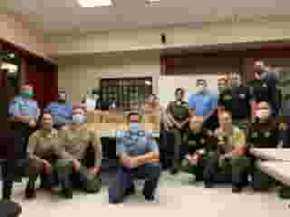 Group photo of West Hollywood Sheriffs in room at station wearing masks.