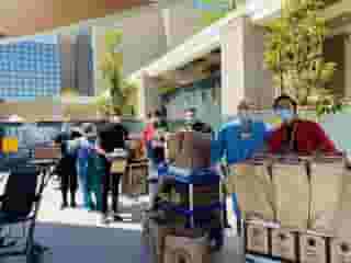 Nurses outside of Kaiser Permanente Woodland Hills Medical Center with carts and bags of Urth food