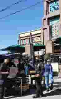 Loading Urth Caffé Lunch Boxes into Police van in front of Urth Downtown
