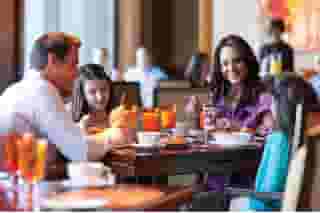 family sitting at table with drinks