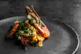 Lobster & Pasta: Grilled lobster with linguini and grilled broccoli, tossed in light soy sauce and fresh herbs.