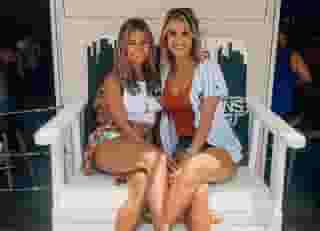 two women on white bench