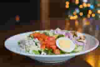 Cobb Salad with a glass and bottle of white wine
