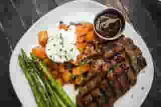 Cowboy Ribeye Steak w/ Grilled Asparagus & Roasted Potato, Bacon, Cheddar, Scallion, Sour Cream Hash