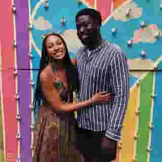Couple posing in front of a mural