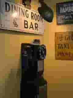Old school pay phone with wall art