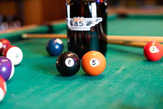 Black and orange pool balls lined up with the numbers 8 5