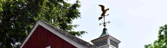 shot of top of a barn with weathervane