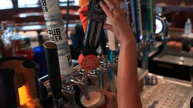 employee pouring beer