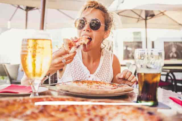woman eating pizza