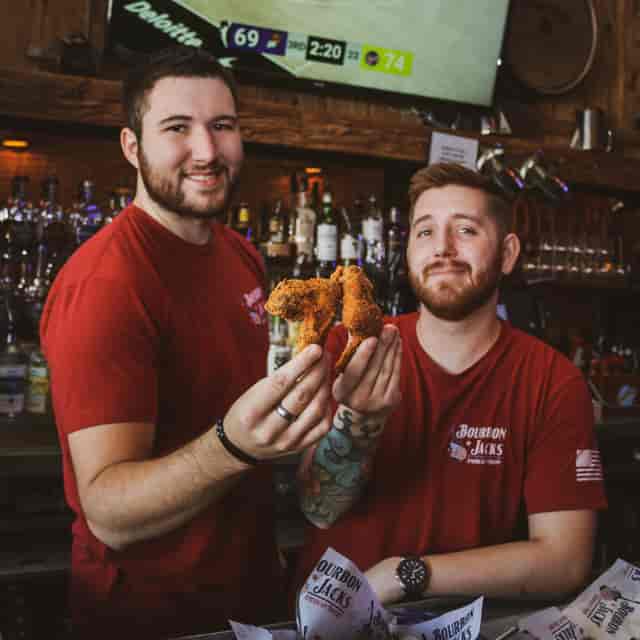Staff holding up chicken tenders