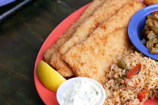 plate of fried fish, rice, and vegetables