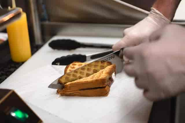 grilled cheese being sliced