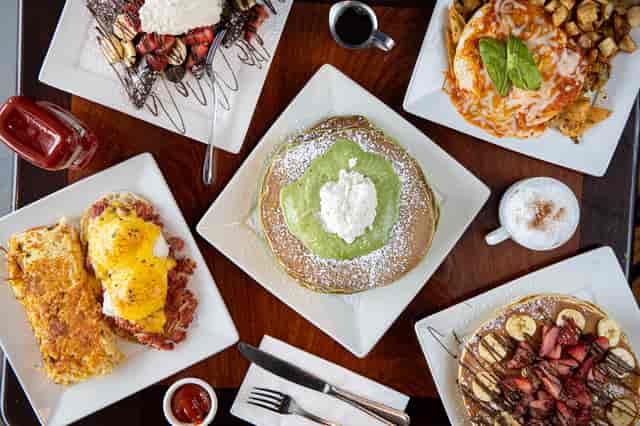 overhead shot of several plates of breakfast food