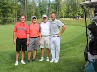 four people on golf course