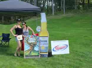 two people on golf course next to beer signs