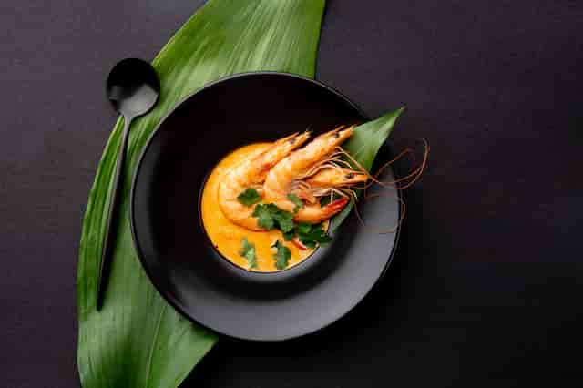 Prawn Curry: Whole prawns immersed in a yellow curry.