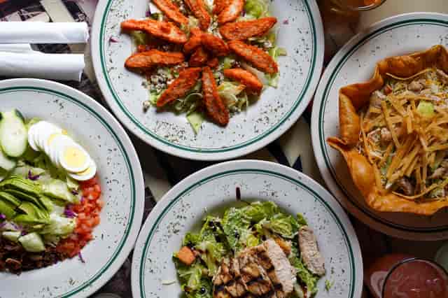 overhead shot of four plates of food