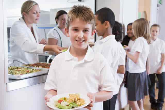 child holding a plate of food