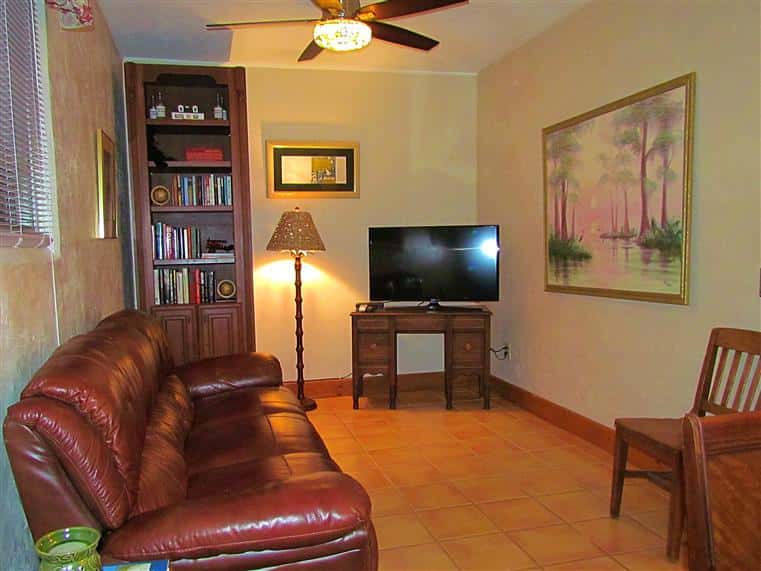 The Sojourner interior with couch, lamp, bookshelf and TV