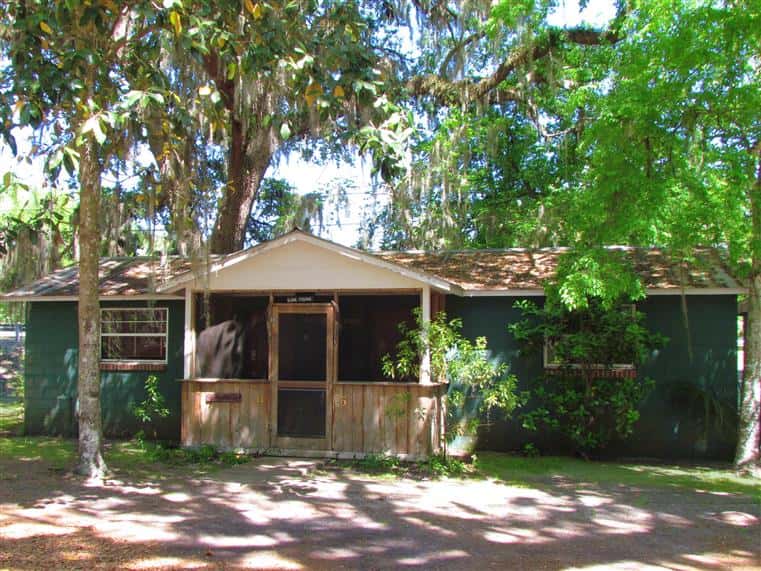 exterior of golden apples and cross creek cabins surrounded by a wooded area