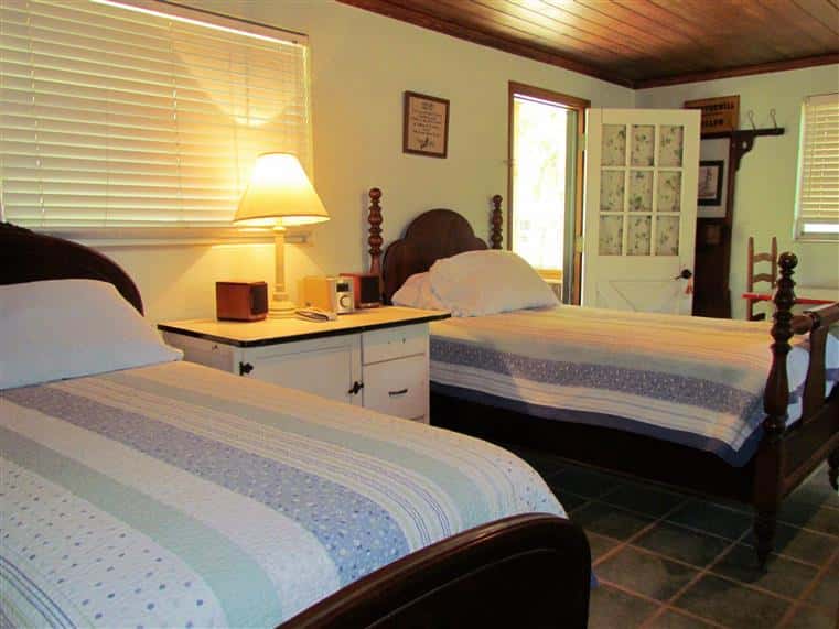 interior of whippoorwill cabin with twin beds and a night stand