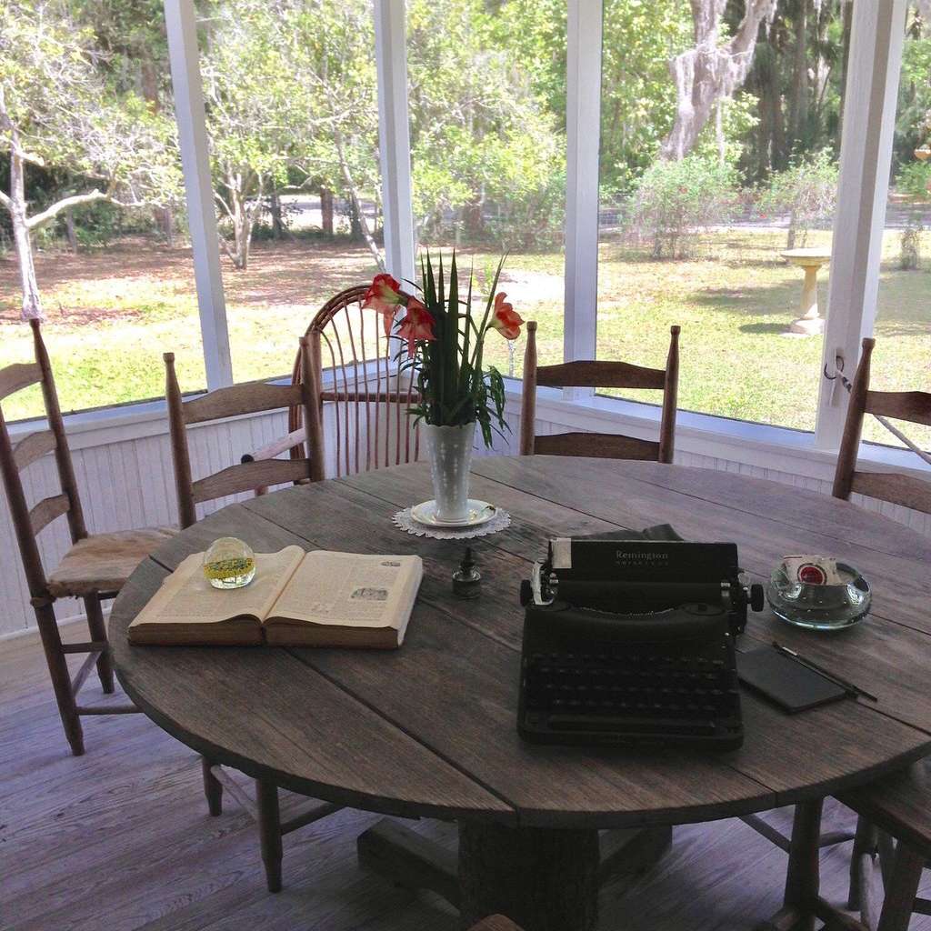 outdoor wooden patio table setting with chairs