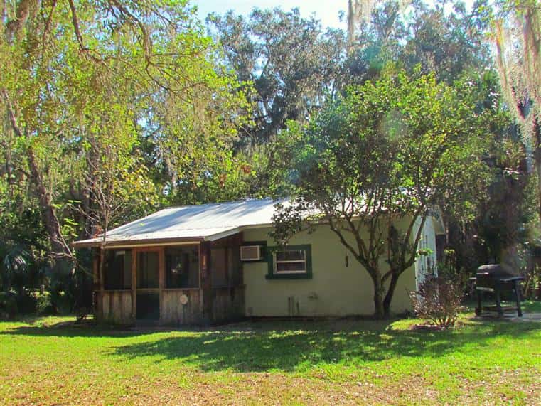 The Sojourner cabin front entrance, located next to trees