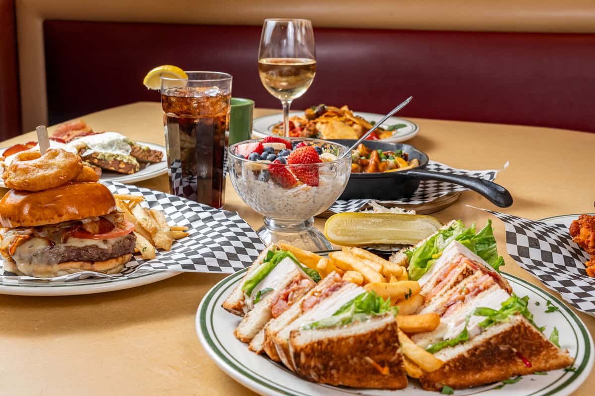 Spread of food including sandwiches, soda, wine and more