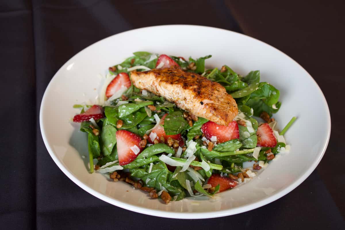 Photo of a salad with Salmon and strawberries.