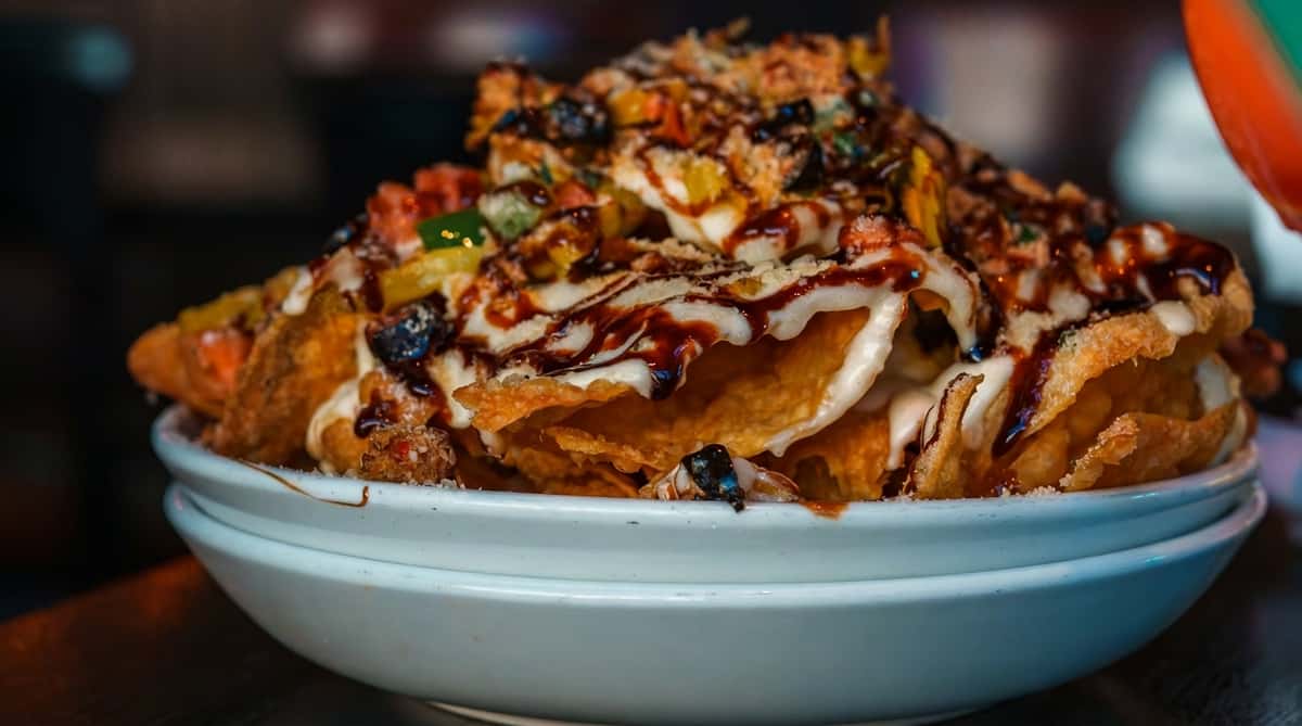 Loaded fries topped with melted cheese, savory meat, and house-made sauce at Oak & Pie in Wichita, KS