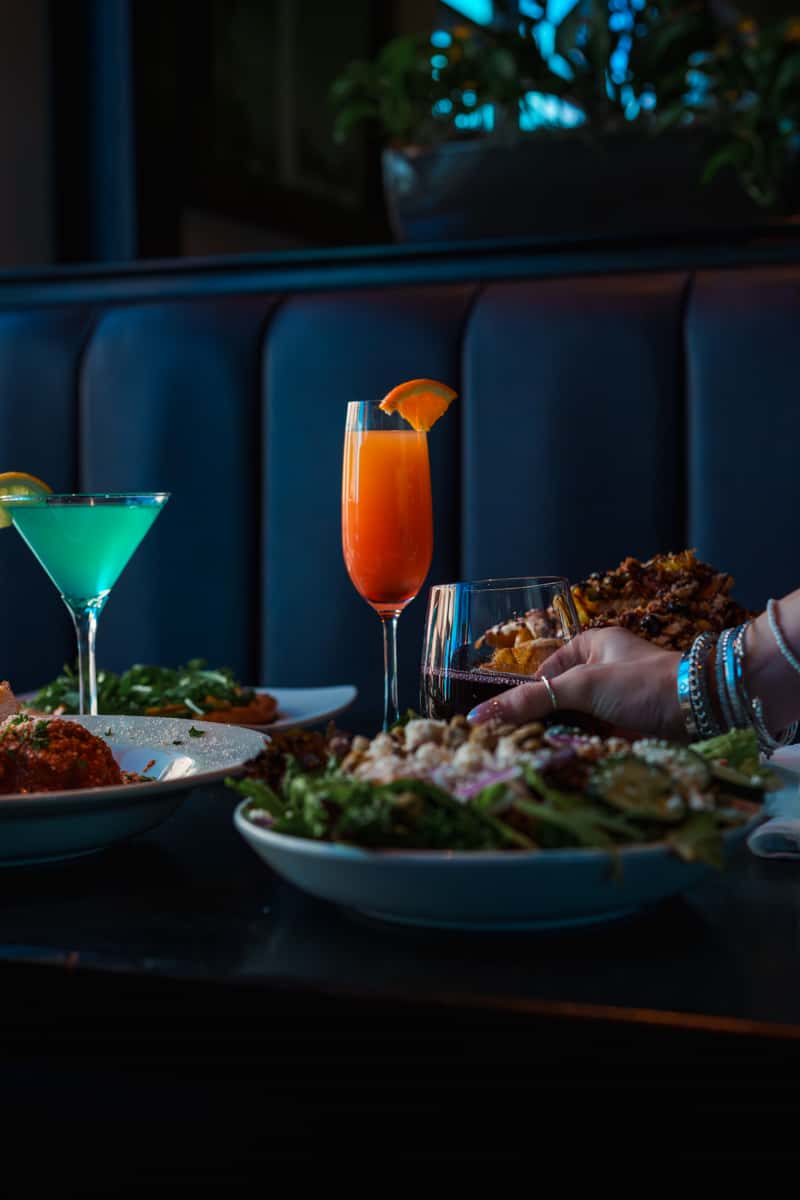 Family-style dining with salads and cocktails at Oak & Pie