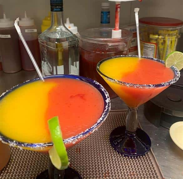two frozen margaritas with straws
