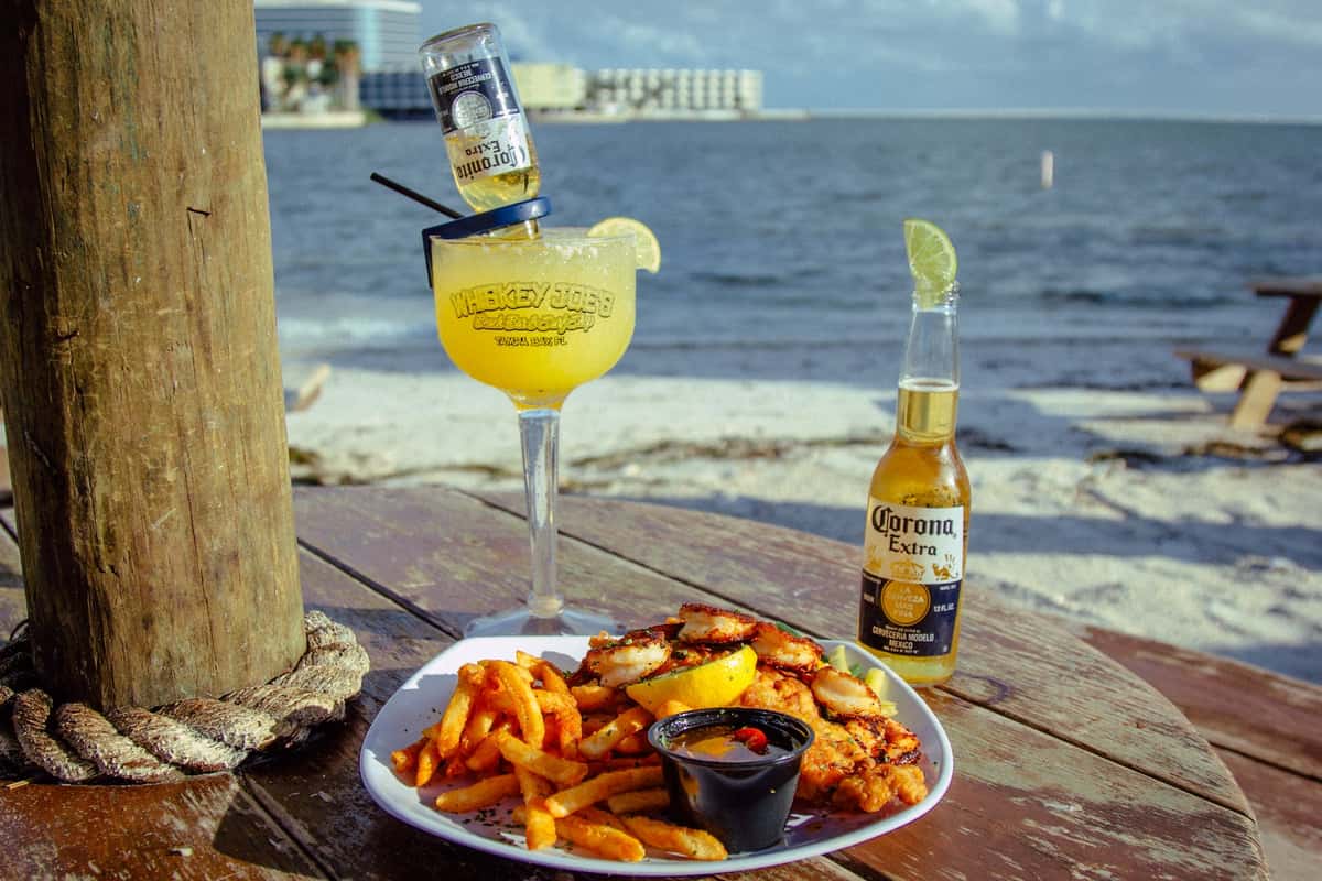 a seafood entree with a beer and margarita
