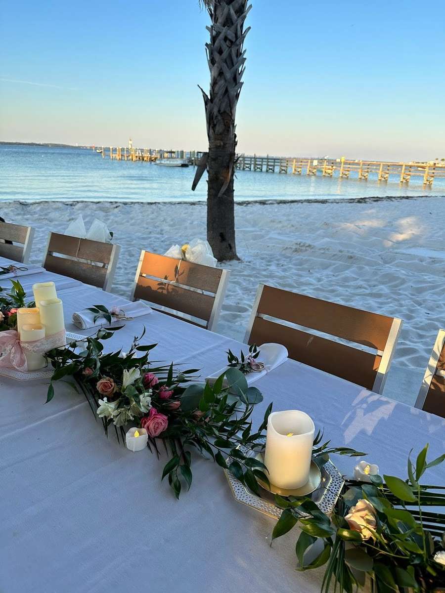 table with flower decoration and candles on the seaside